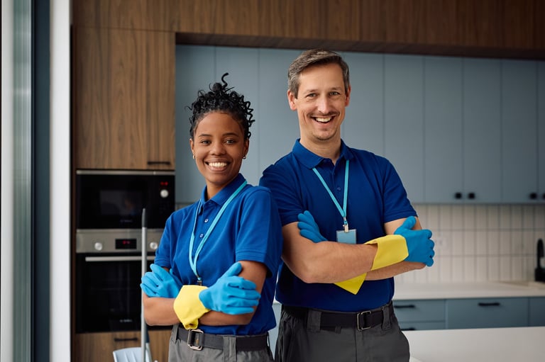 Happy diverse professional cleaners standing with arms crossed